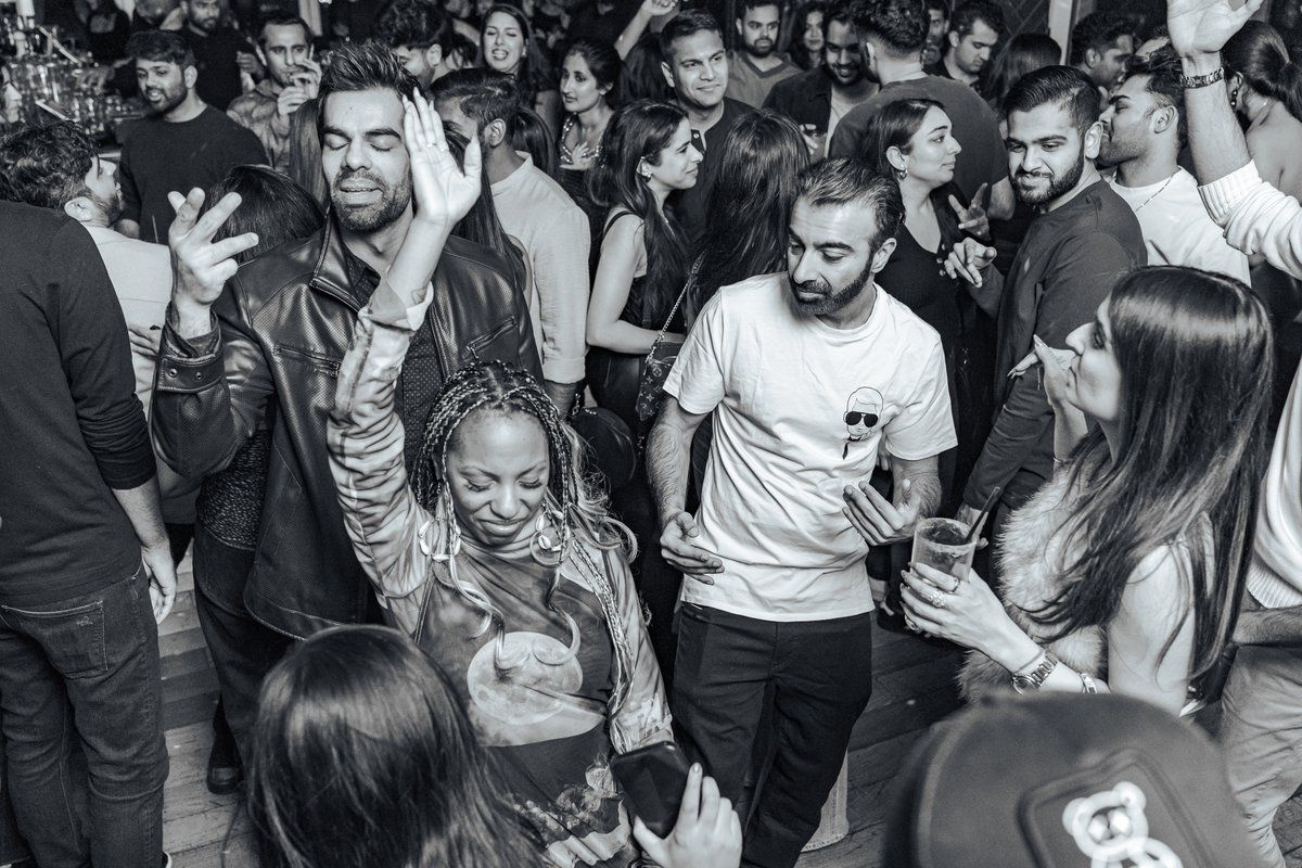 Black and white photo of a packed, dancing crowd