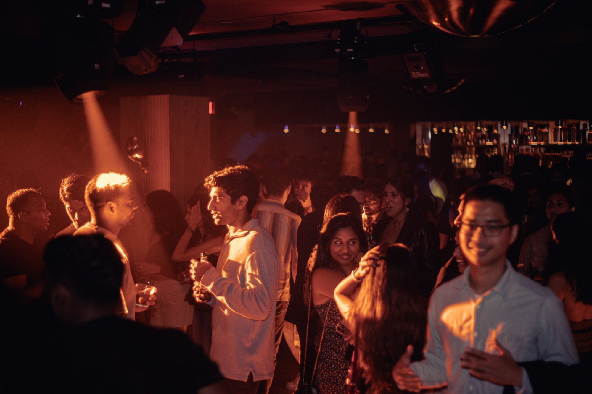 A full room under amber light at The Penthouse at Elsie
