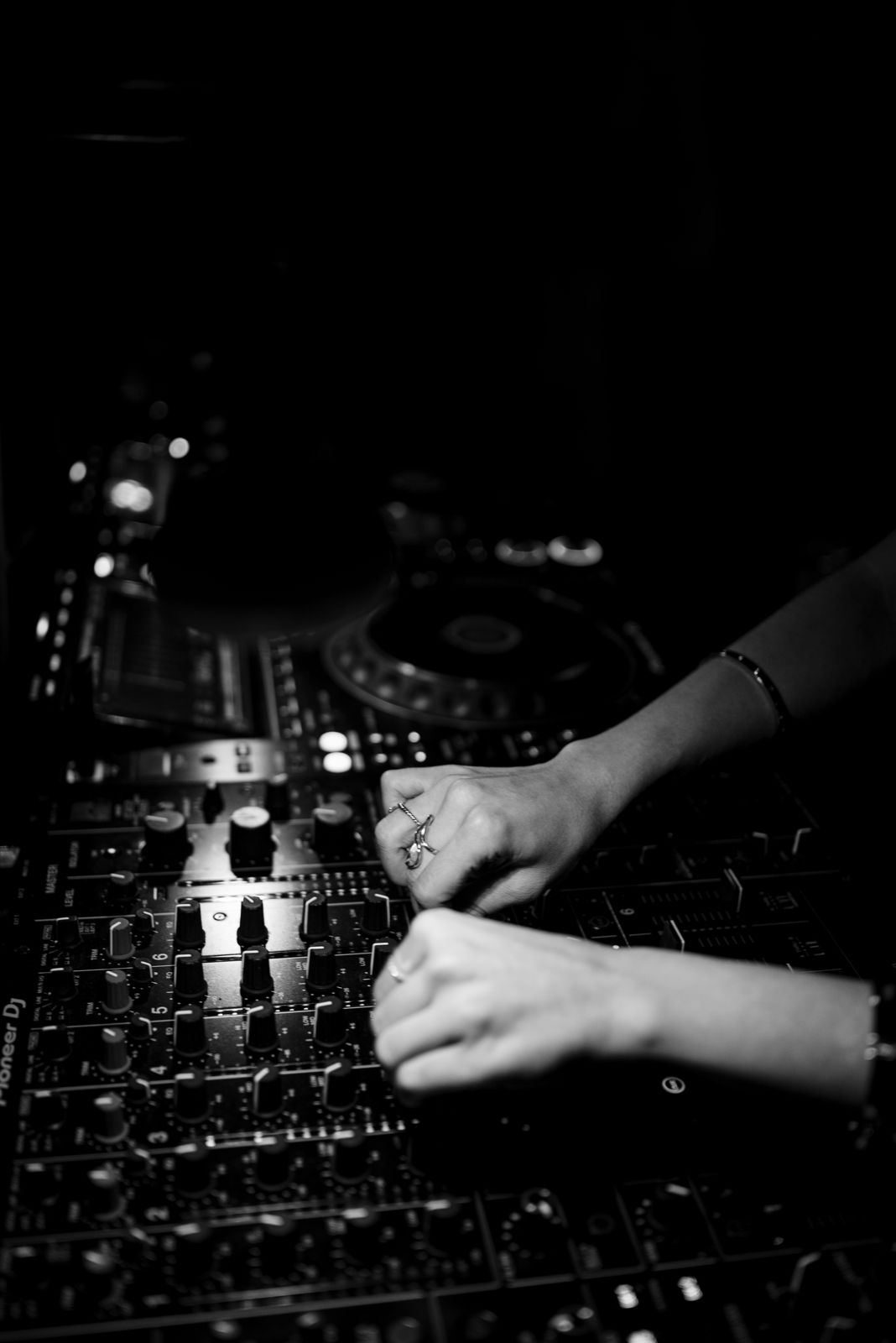 Black and white photo of Hermina's hands on the mixer at Public Hotel